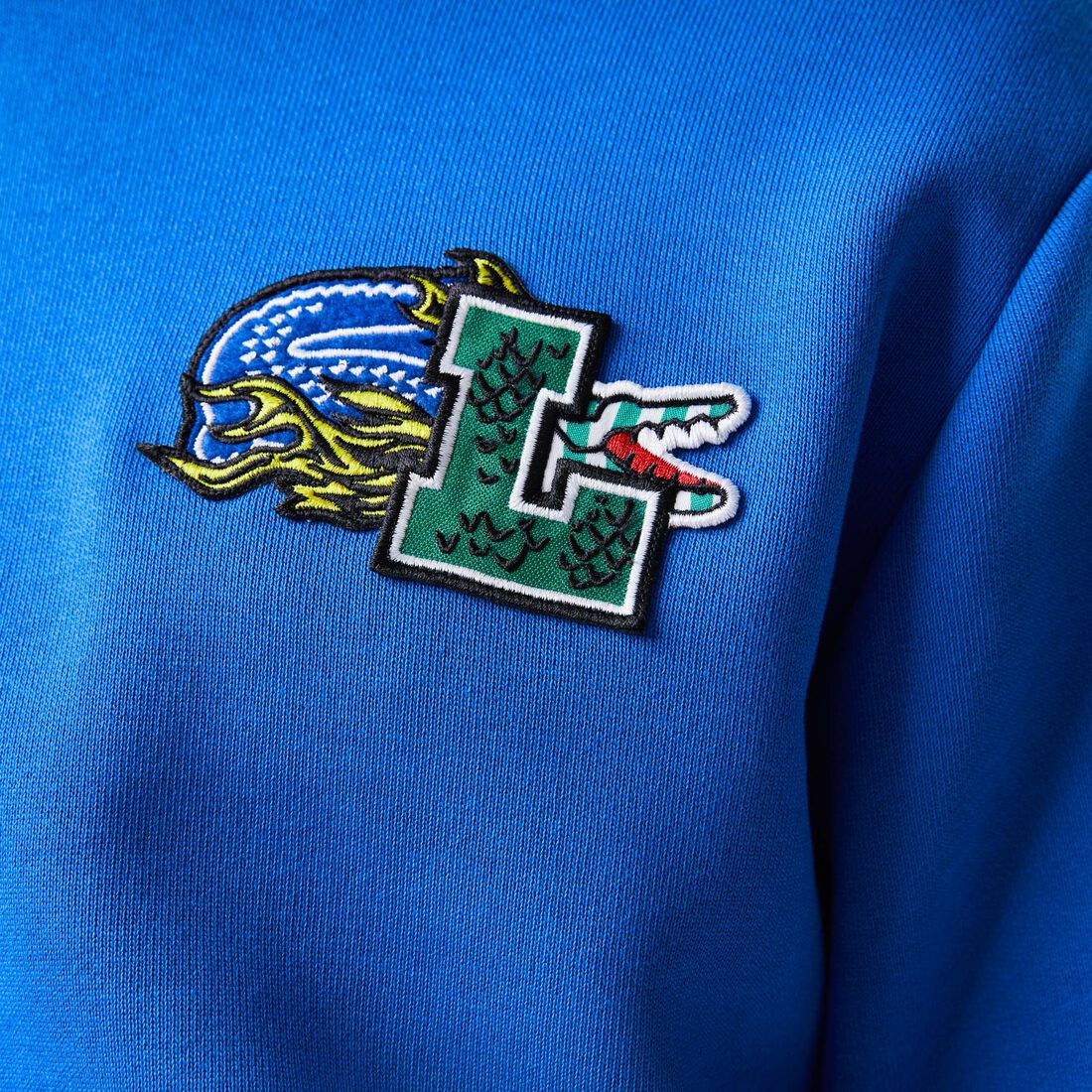 سويت شيرت بغطاء رأس لاكوست بنقشة قصص مصورة من تشكيلة موسم الأعياد للرجال سويت شيرت بغطاء رأس لاكوست بنقشة قصص مصورة من تشكيلة موسم الأعياد للرجال